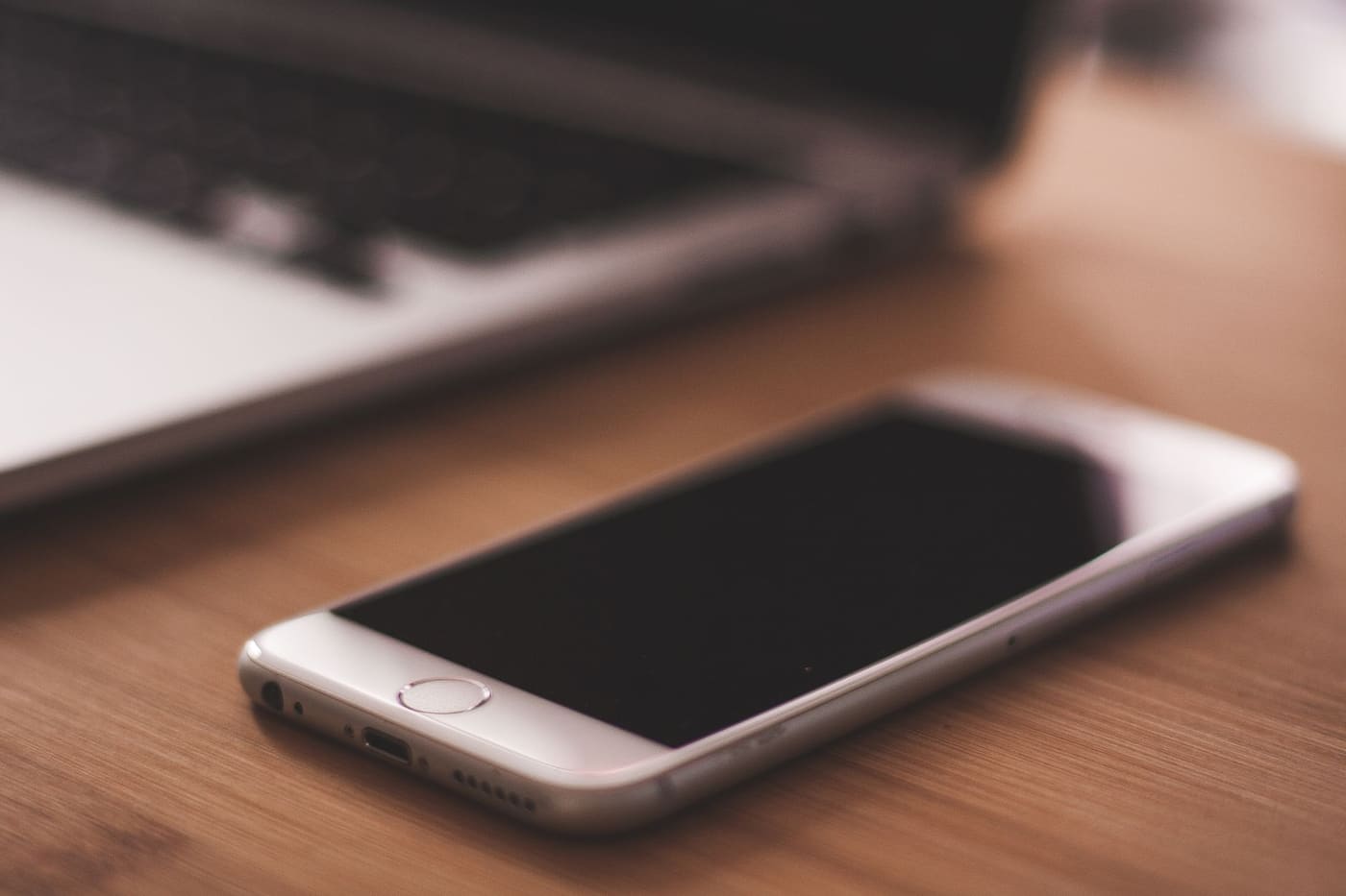 A smartphone lying on a wooden table
